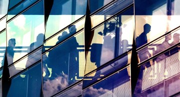 Image of people riding escalator up.