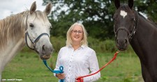 Jude Jennison stands with Mr Blue, left, and Gio, two of the horses she uses in her Leadership With Horses course that helps executives develop their leadership skills.
