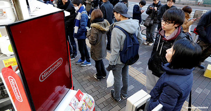 People queue up to purchase the Nintendo Switch game console outside an electronics store in Tokyo in March 2017.