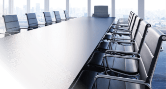 Photo of desk with executive chair at the head.